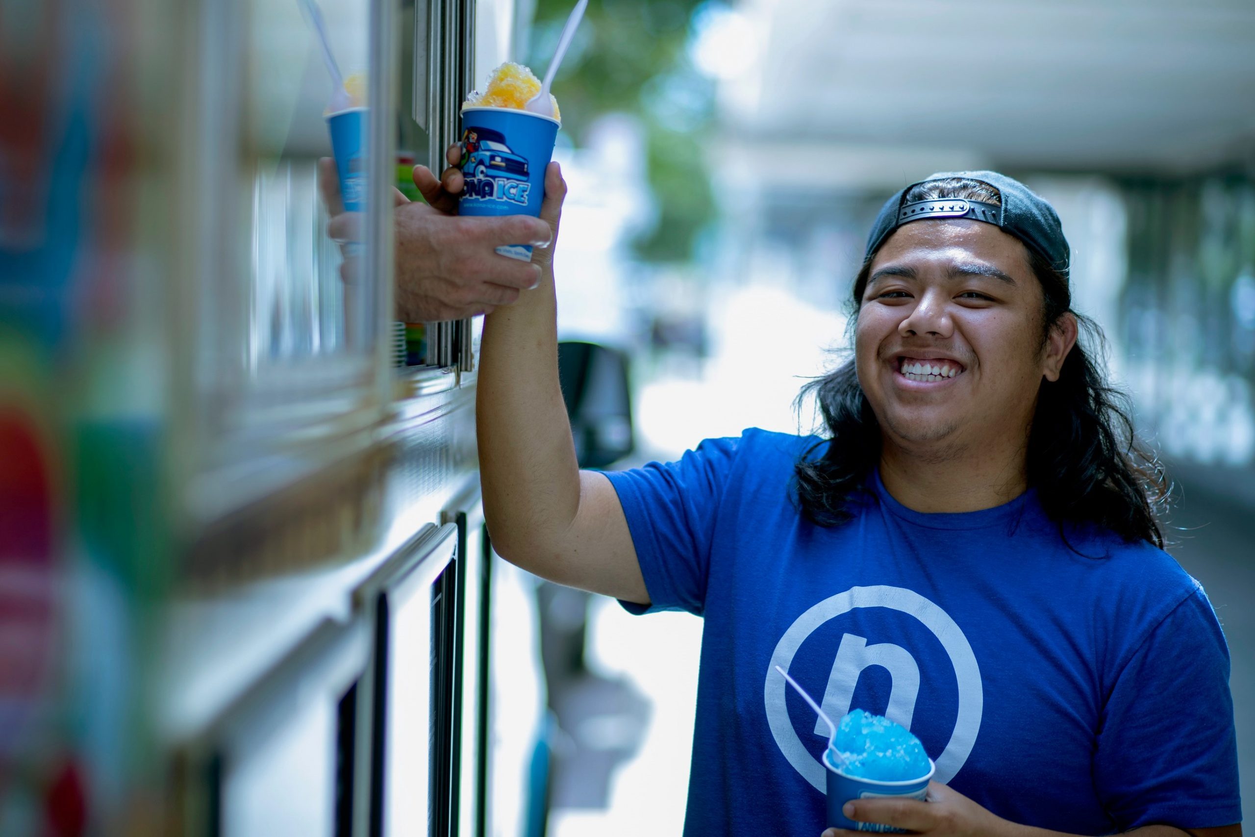 Nelnet associate at food truck receiving Kona shaved ice
